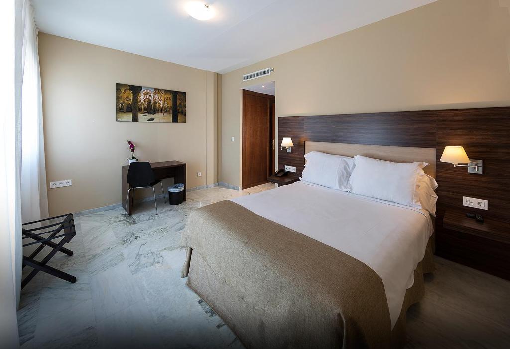 A bed or beds in a room at Hotel Finca Los Abetos
