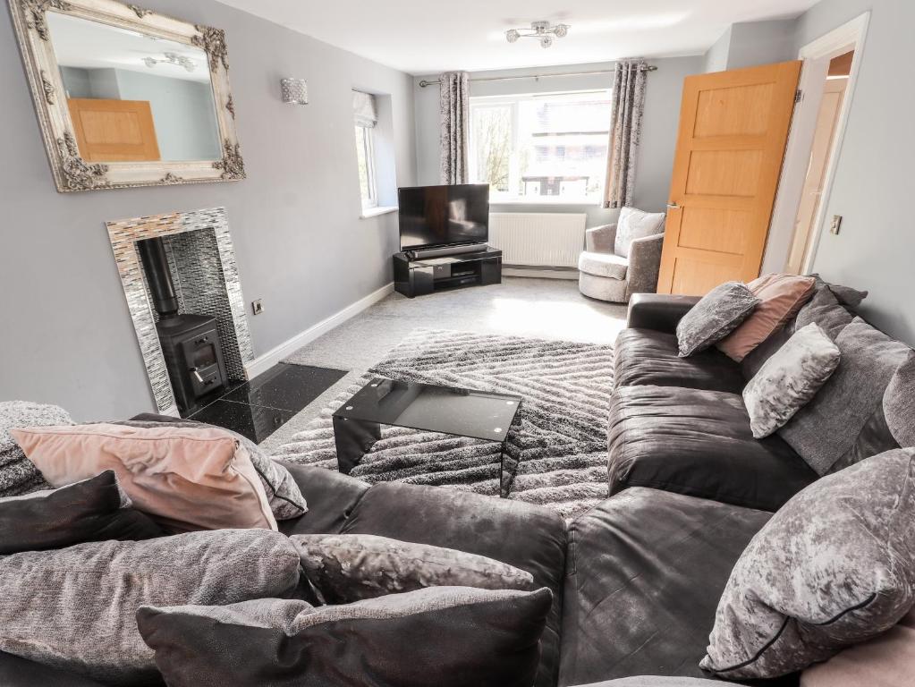 ein Wohnzimmer mit einem Sofa und einem Spiegel in der Unterkunft Nant House in Wrexham