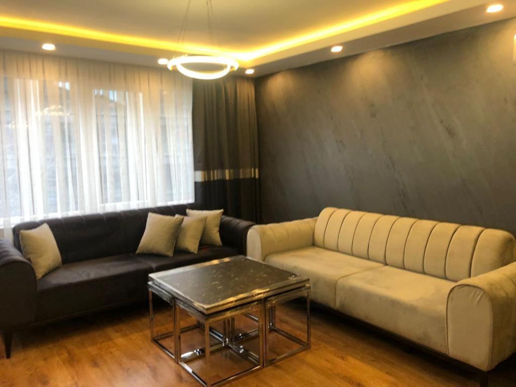 een woonkamer met een bank en een tafel bij Istanbul Suites Residance Super Lux BKY in Istanbul