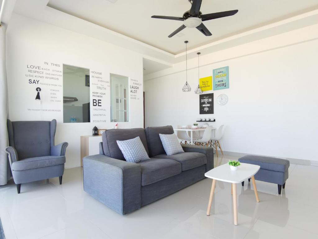 a living room with a couch and two chairs at One Homestay C 6pax 2Rooms in Sibu