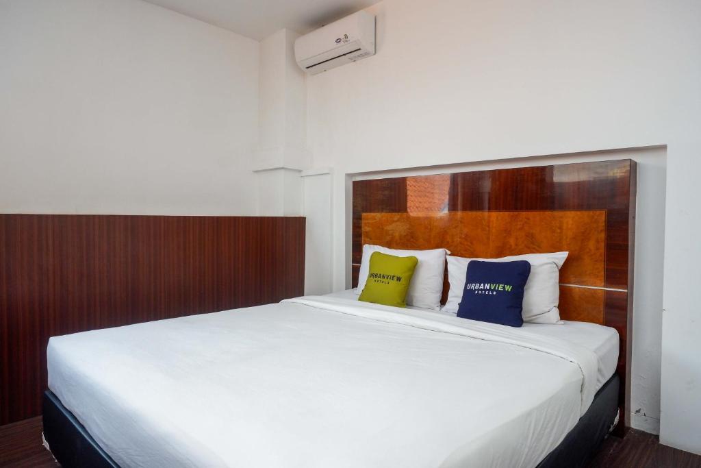 Postel nebo postele na pokoji v ubytování Urbanview Hotel Artama Simpang Lima by RedDoorz