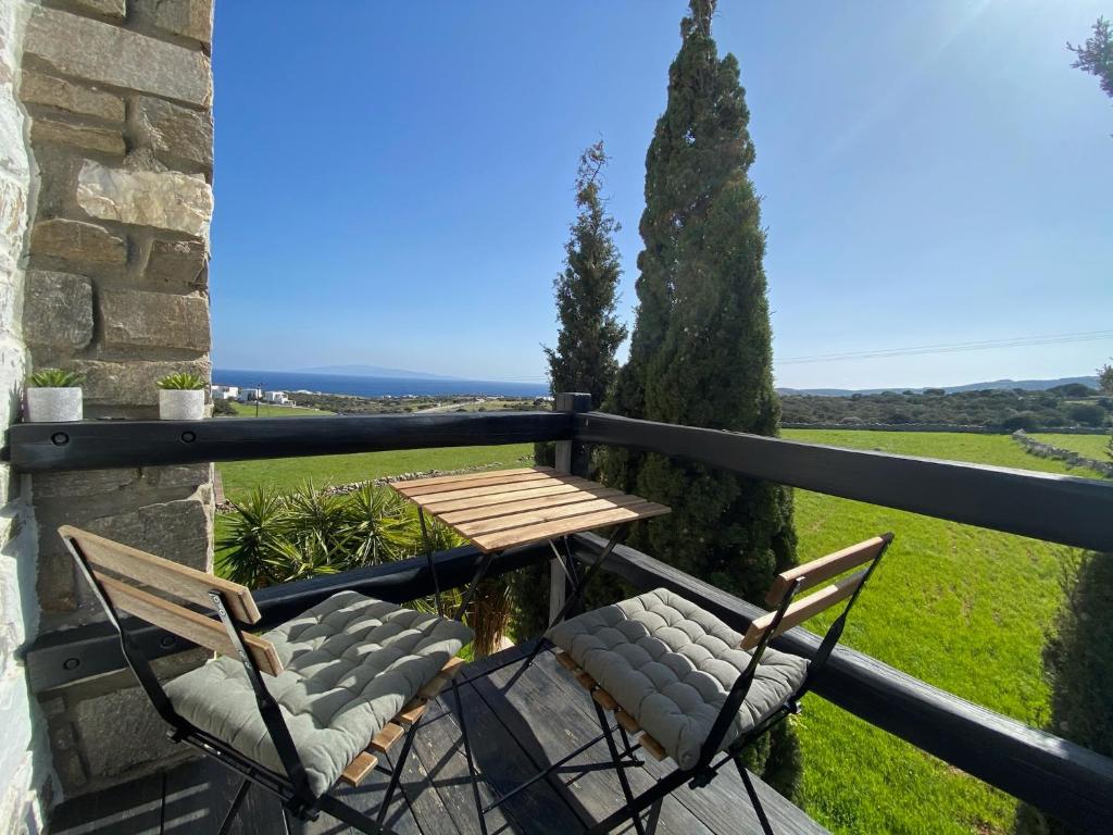 a table and chairs on a balcony with a view at Wood & Stone - Paros in Aspro Chorio Paros