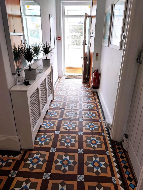a hallway with a tiled floor in a house at St Breca in Newquay