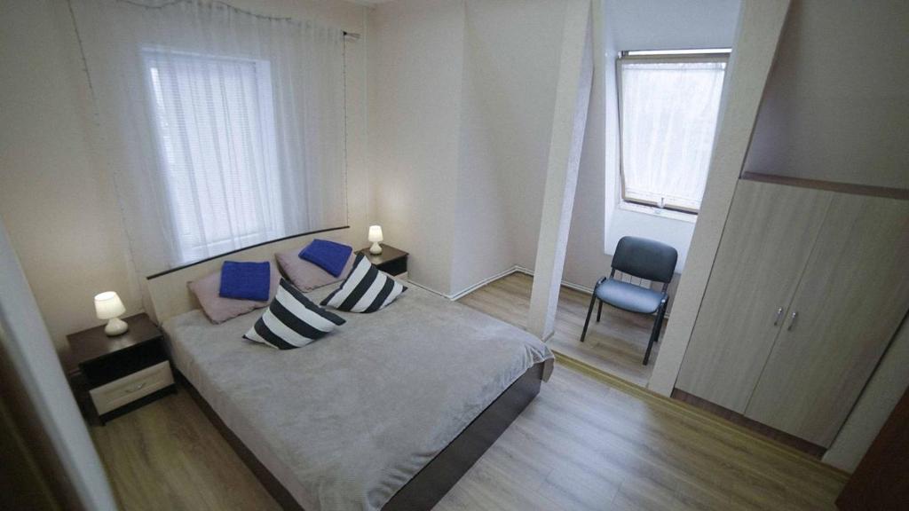 a bedroom with a bed and a chair and a window at Митяевский Mityaevskyi Guest House in Kolomna