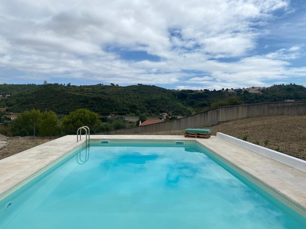 a swimming pool with a view of a mountain at Casa da Azinhaga in Alenquer
