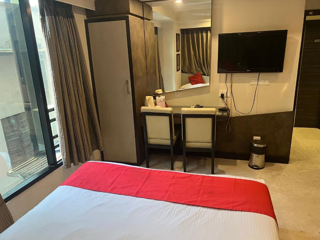Postel nebo postele na pokoji v ubytování Hotel Aston International