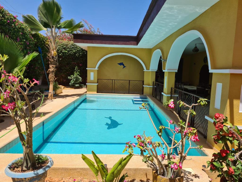 a swimming pool in the middle of a house with plants at keur GAANSOTI in Somone