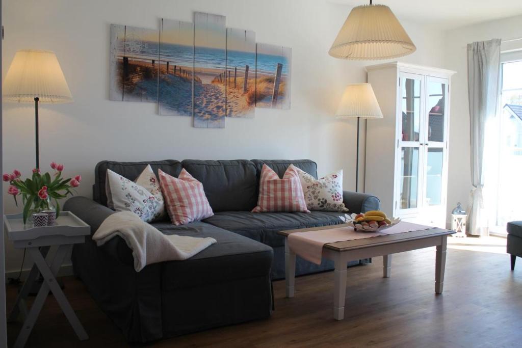 a living room with a couch and a table at Ferienwohnung Abendsonne in Born