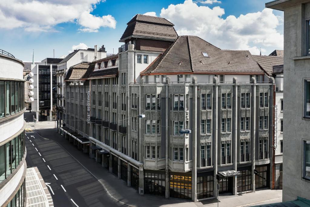 a large building with a brown roof on a street at Boutique Hotel Seidenhof in Zurich