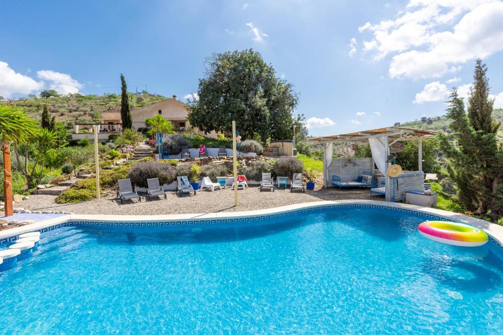 a swimming pool with a frisbee in a yard at Finca Las Nuevas Casa Maria Arriba in Alora