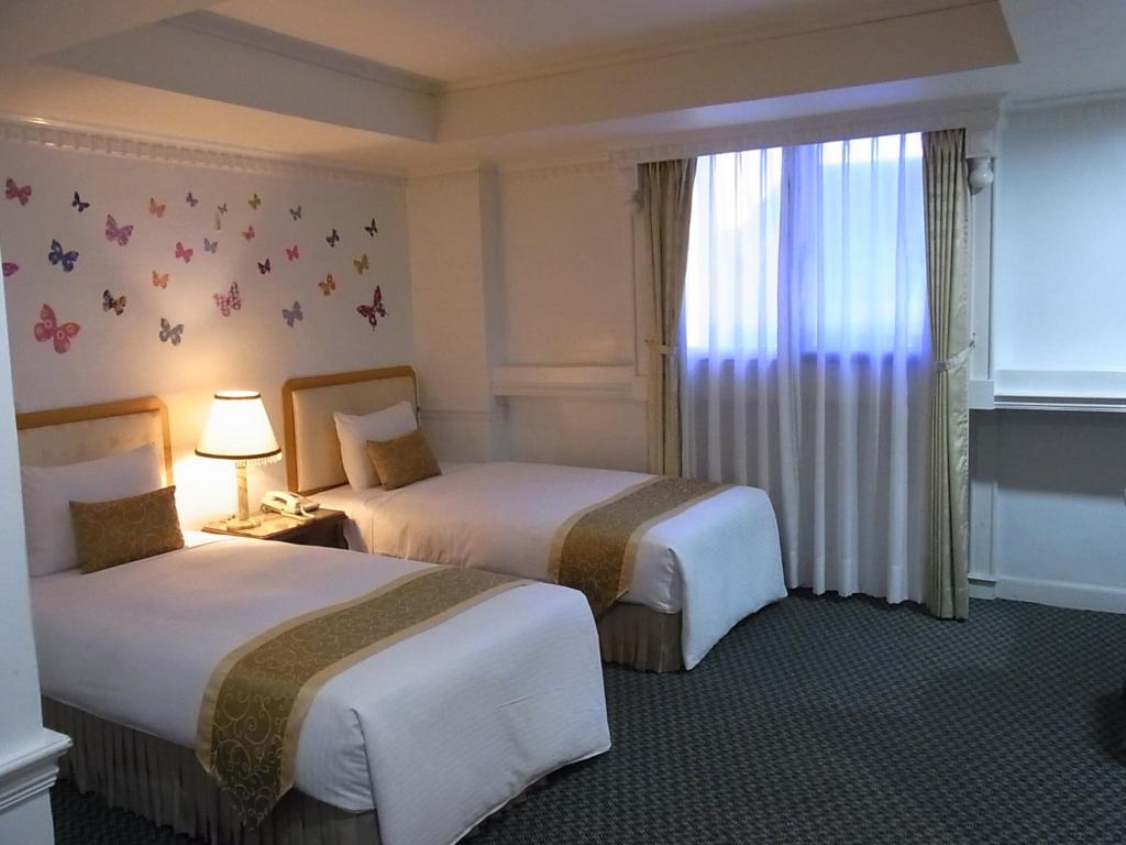 Postel nebo postele na pokoji v ubytování City Hotel