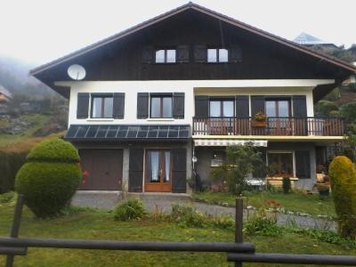a house with solar panels on the front of it at Gîte dans hameau in Ugine