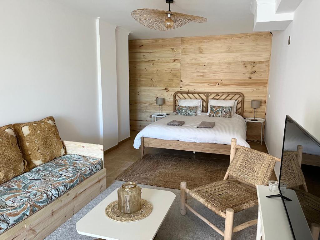 a bedroom with a bed and a couch at Sesimbra Natural Room and private access in Sesimbra
