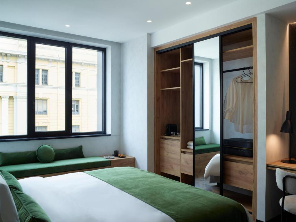 A bed or beds in a room at The Port Square Hotel