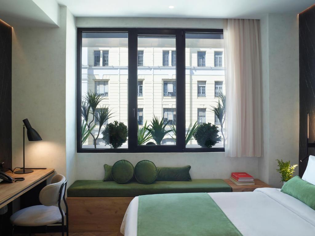 A bed or beds in a room at The Port Square Hotel