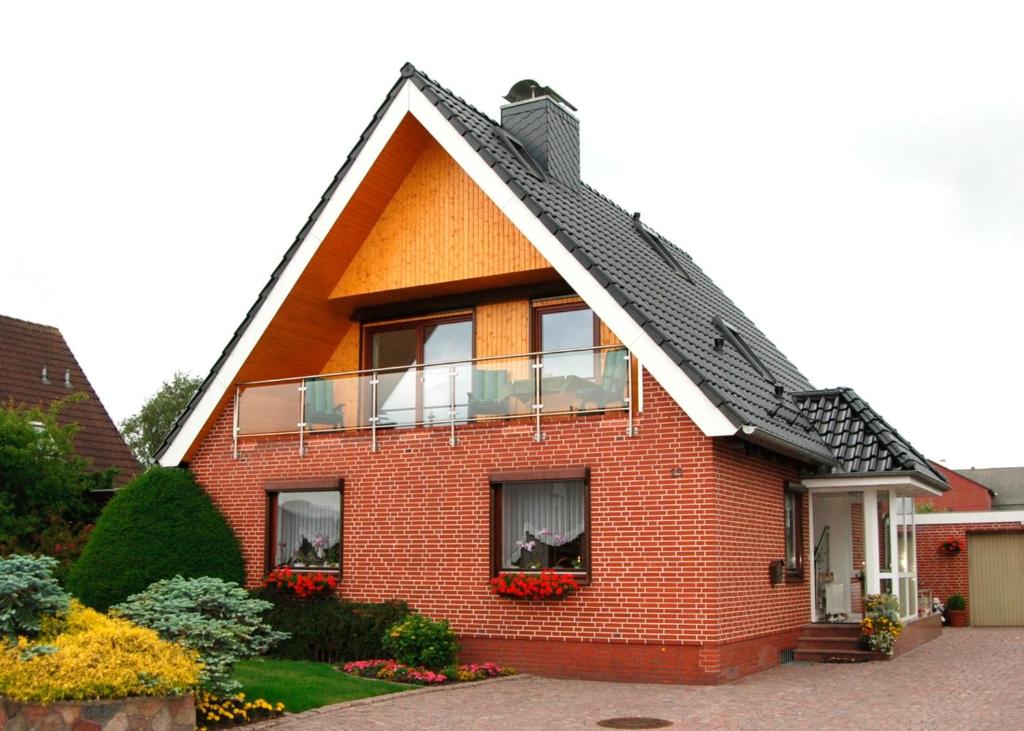 uma casa de tijolos vermelhos com um telhado de gambrel em FW Hannelore em Grossenbrode