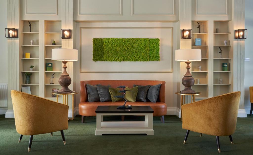 a living room with a couch and two chairs at Powerscourt Springs Health Farm in Wicklow