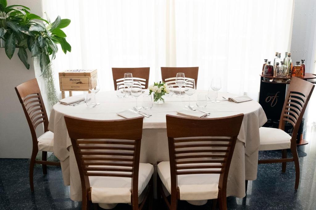 a white table with chairs and a white table cloth at Hotel Mirage in Viareggio