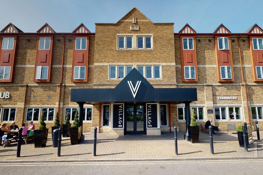 a building with a sign on the front of it at Village Hotel Maidstone in Maidstone