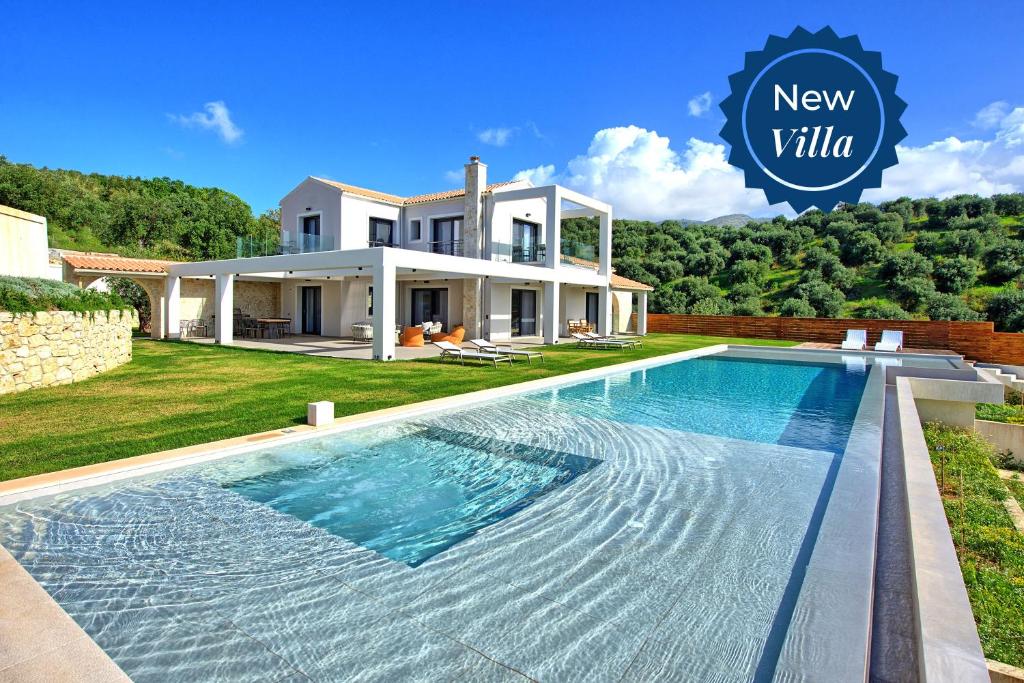 a villa with a swimming pool in front of a house at Luxury Villa Ebellina by PosarelliVillas in Acharavi