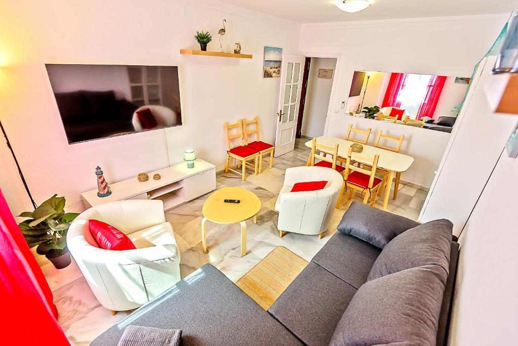a living room with a couch and chairs and a table at Plaza de Cárcel 3-bedroom Apartment in El Puerto de Santa María