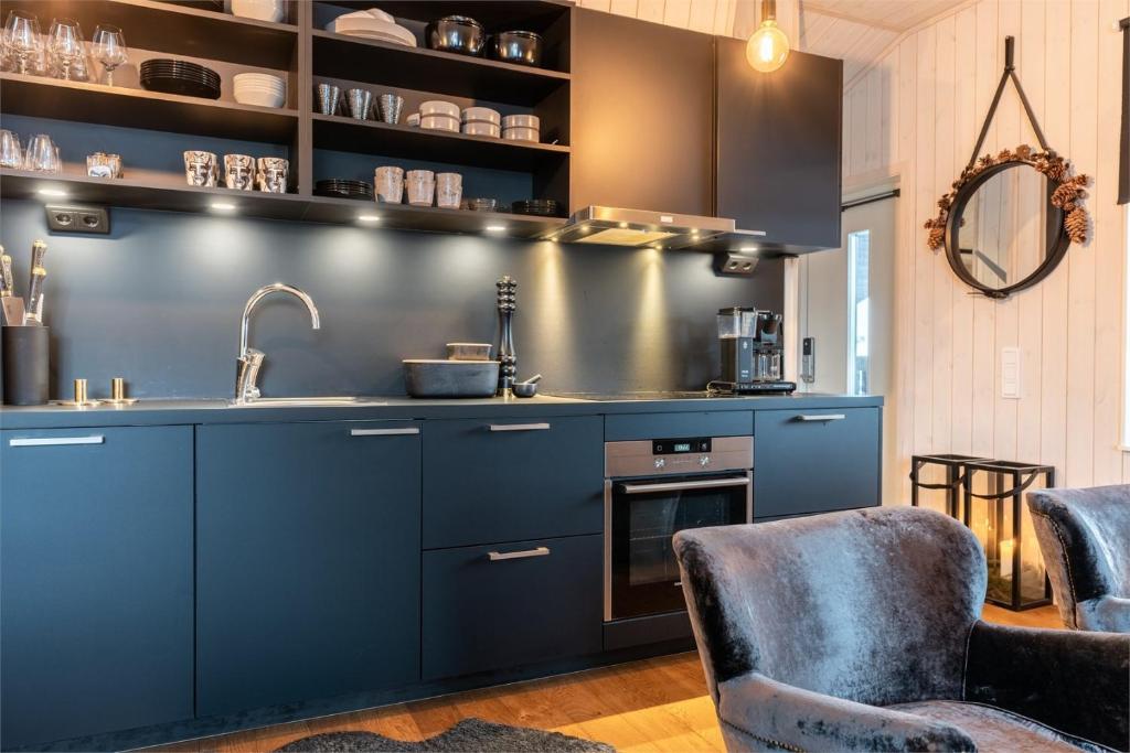 a kitchen with blue cabinets and a sink at Fjällnära Skilodge 19 in Sälen