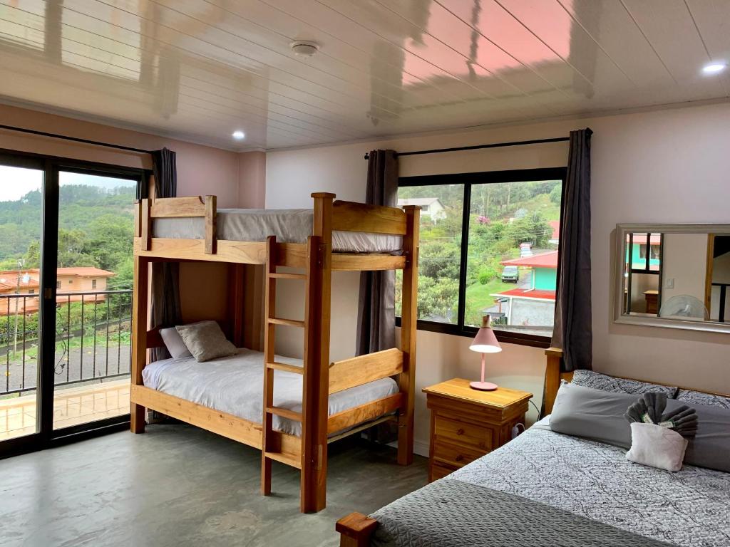 a bedroom with two bunk beds and a window at Buena Vista Boquete in Boquete
