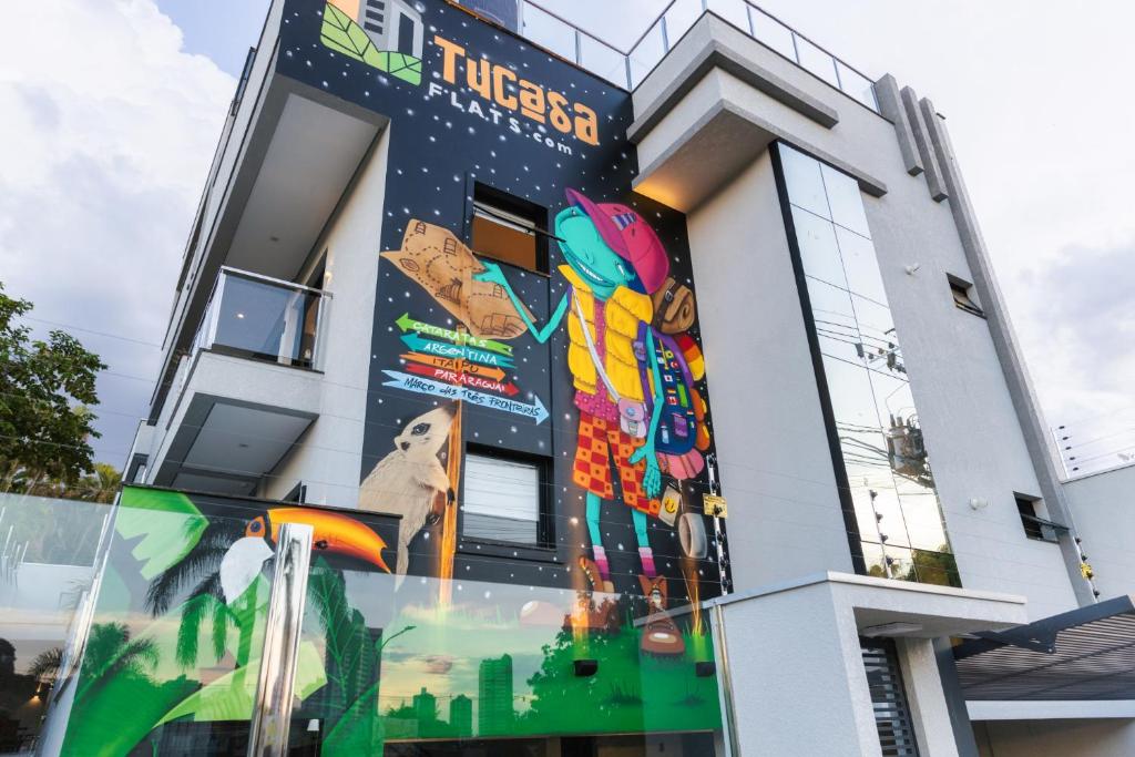a building with a mural on the side of it at TuCasa Flats - Viva uma experiência de morador! in Foz do Iguaçu