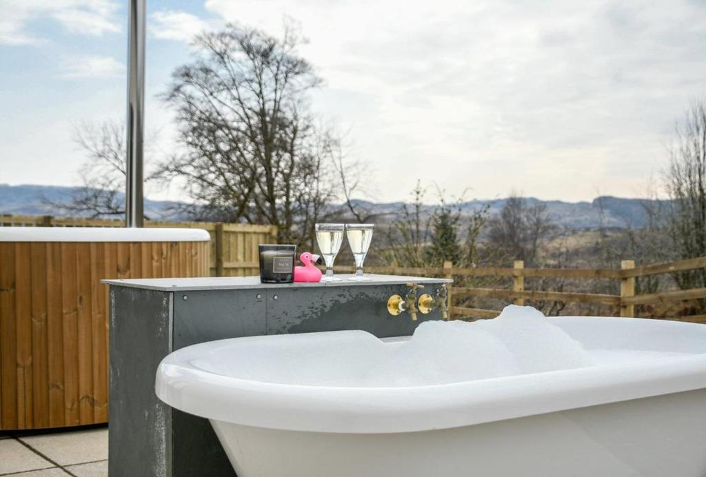a bath tub sitting on top of a deck with a view at Blackmount House in Oban
