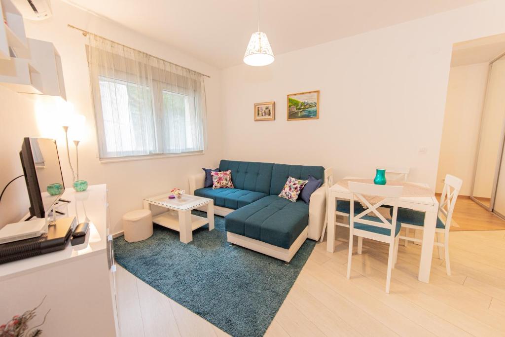 a living room with a couch and a table at Apartment Peace in Kotor
