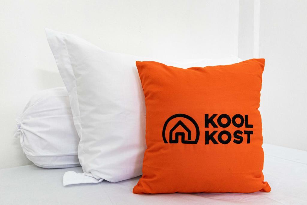 ein orangefarbenes Kissen mit dem Kodak-Logo darauf in der Unterkunft KoolKost Syariah near Jambi Prima Mall 2 (Minimum Stay 6 Nights) in Jambi