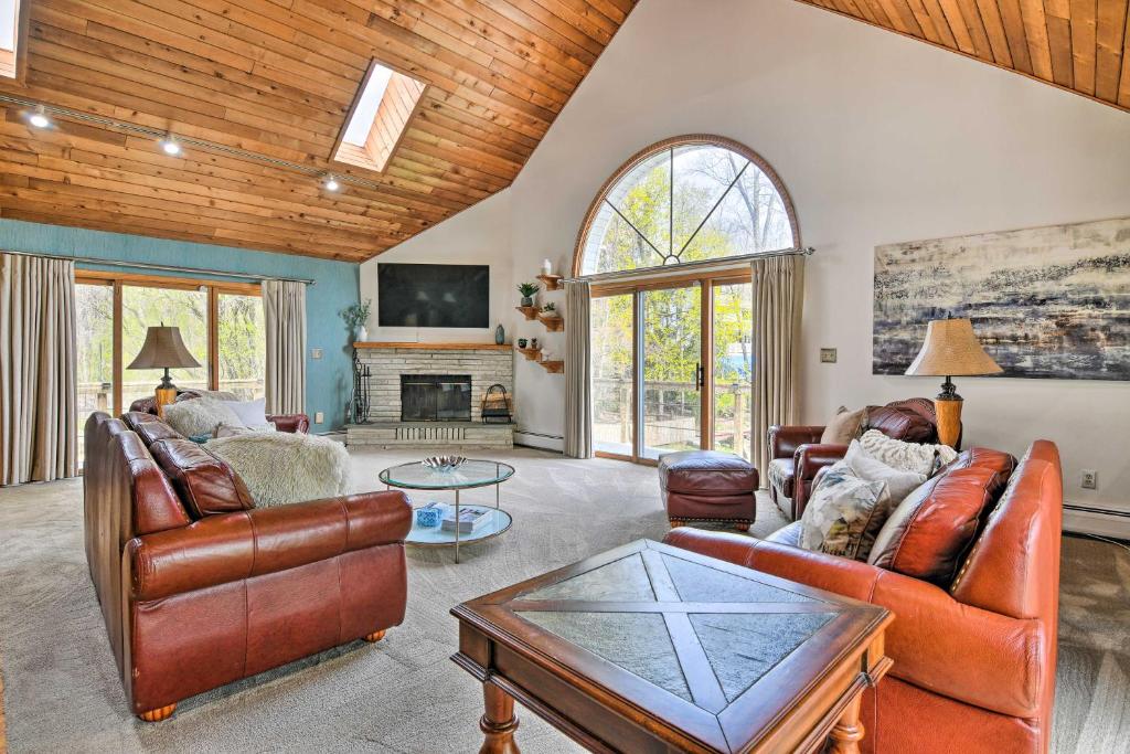 a living room with leather furniture and a fireplace at Decked-Out Home Hot Tub, Pool, Fire Pit and More! in Monroe