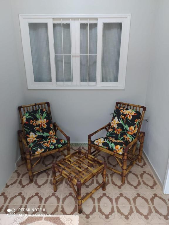 two chairs and a coffee table in a room at CASA DU VÔ - Cantinho Du Vô in Santa Teresa