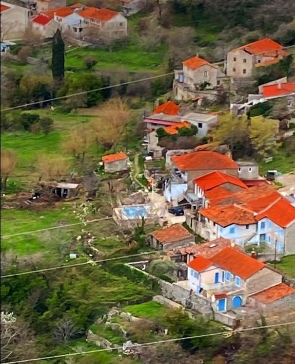 a group of houses with orange roofs on a hill at Apartmani Dumezic in Bar