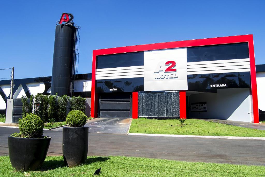 a gas station with a red and white building at A2 Motel in Ribeirão Preto