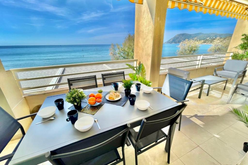a dining table with a view of the ocean at Magnificent 82m With Terrace And In Front Of Sea in La Seyne-sur-Mer