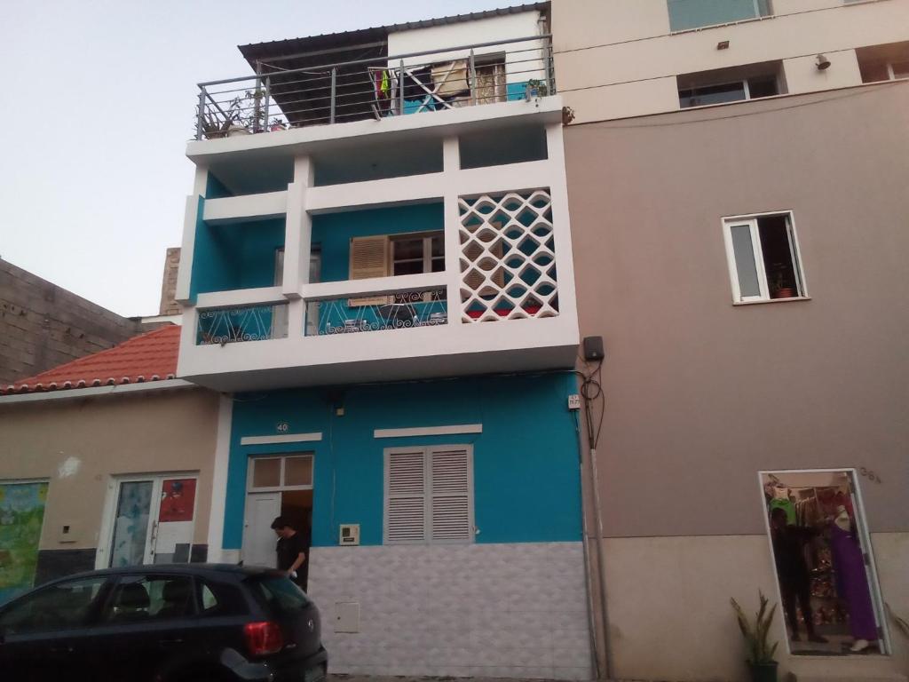 a blue and white house with a car parked in front at In The Heart Of Praia - Family B&B in Praia