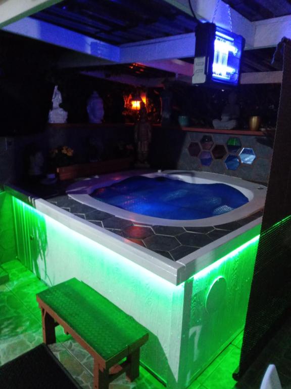 a hot tub in a room with green lights at Mitchell's Guesthouse in Parow