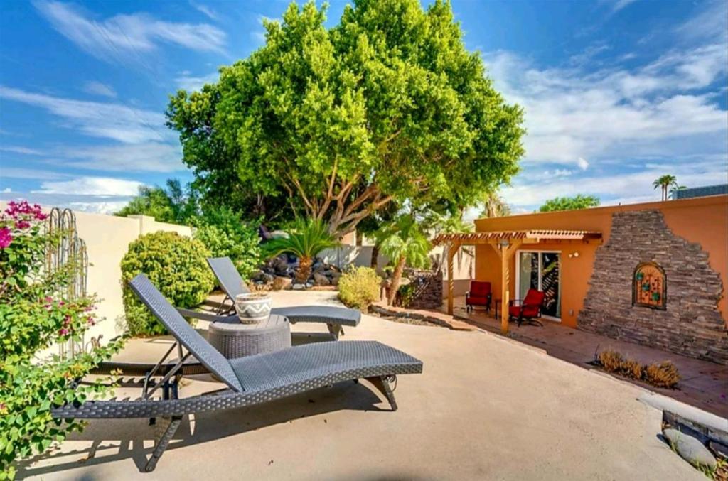 a patio with two chairs and a table at Tranquil oasis near Old Town, hot tub, mountain views in Scottsdale