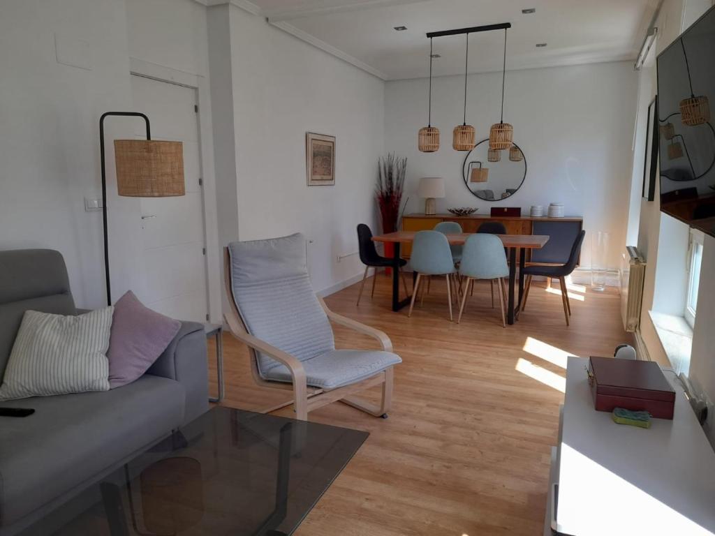 a living room with a couch and a dining room at Amplio piso exterior en el centro de Santander in Santander