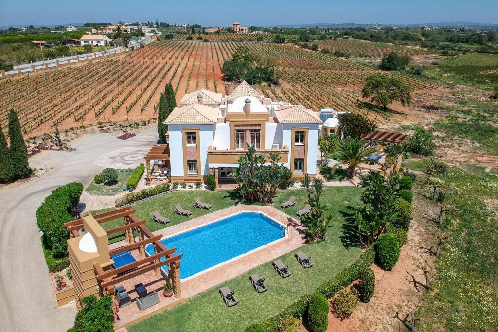 einem Luftblick auf ein Haus mit einem Pool und einem Weinberg in der Unterkunft Quinta Dionysus in Albufeira
