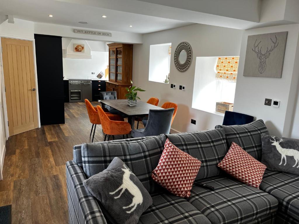 a living room with a couch and a table at The Stables at Cotton (one mile from Alton Towers) in Oakamoor