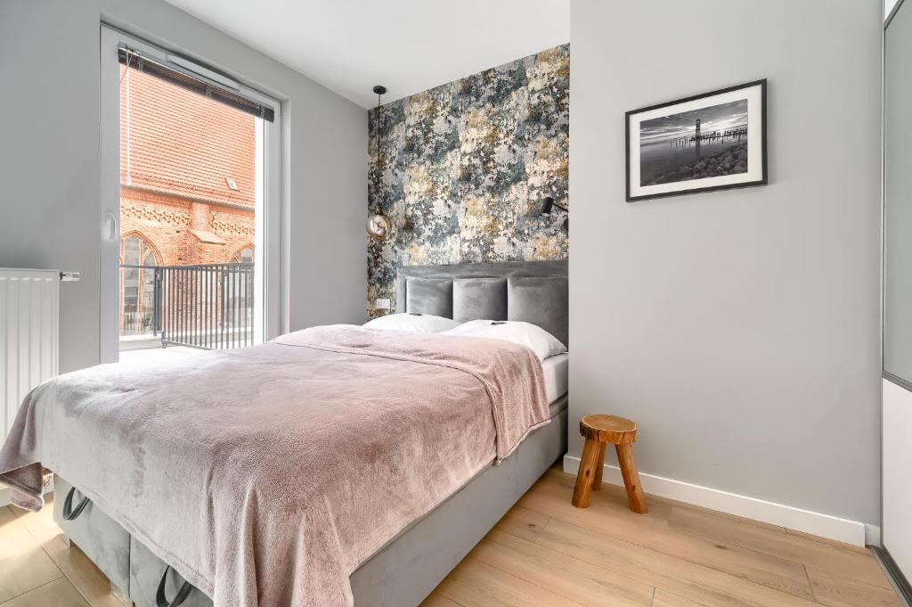 Posteľ alebo postele v izbe v ubytovaní Apartament 1000 Stare Miasto bulwary Apartamenty No 1