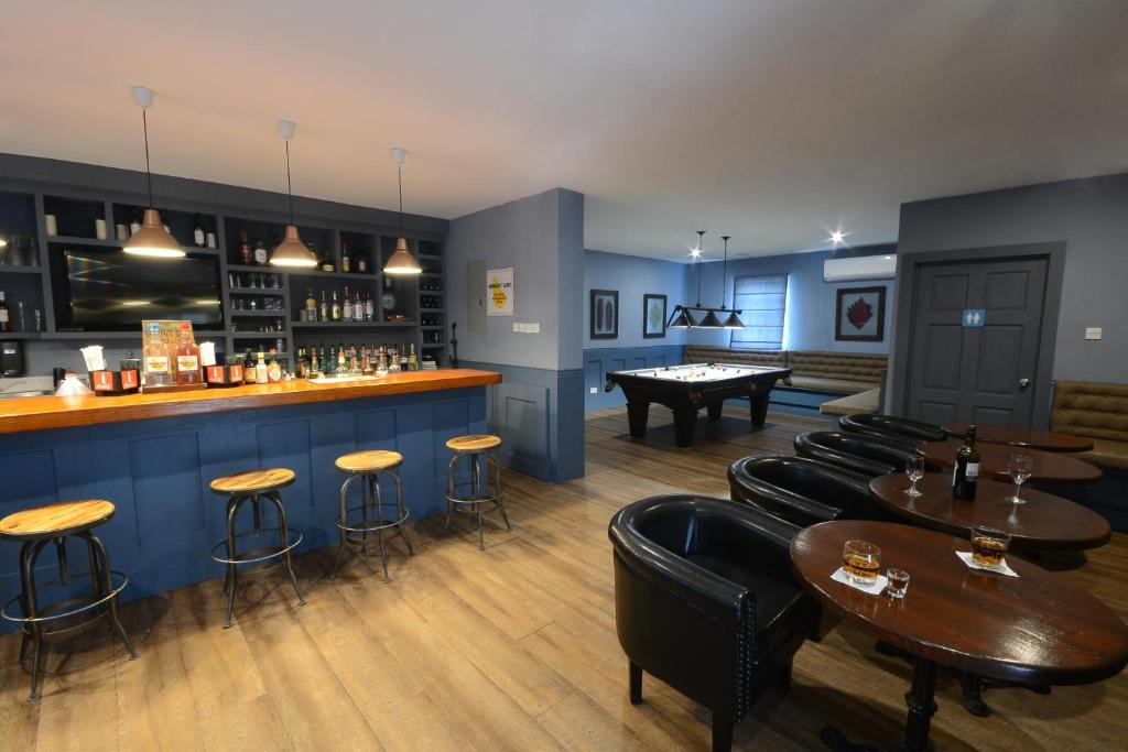 a bar with tables and chairs and a pool table at Sugar Bay Barbados - All Inclusive in Bridgetown