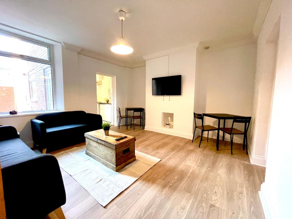 a living room with a couch and a table at Huge serviced Apartment with FREE PARKING in Jesmond