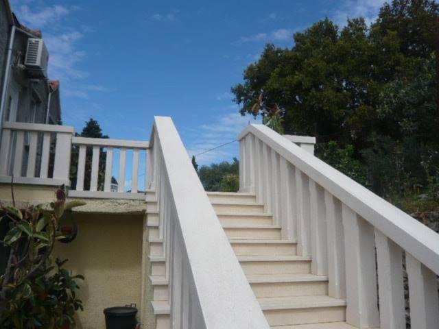 a white staircase leading up to a house at The Olive Tree in Lumbarda