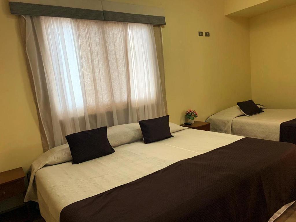 Postel nebo postele na pokoji v ubytování Juku Hostal