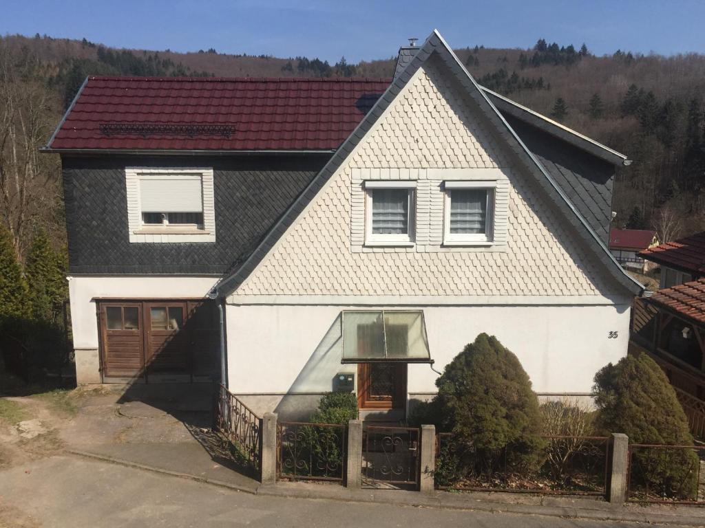 a white house with a black roof at "Haus am Wald" in Benshausen