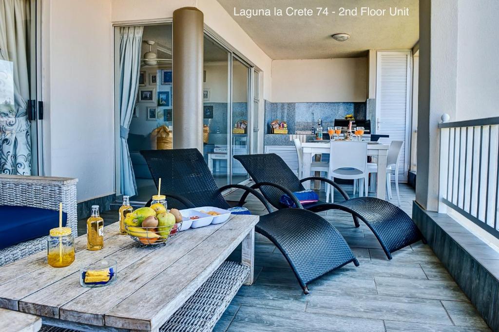 a table with a bowl of fruit on a patio at Laguna la Crete 74 & 90 in Margate