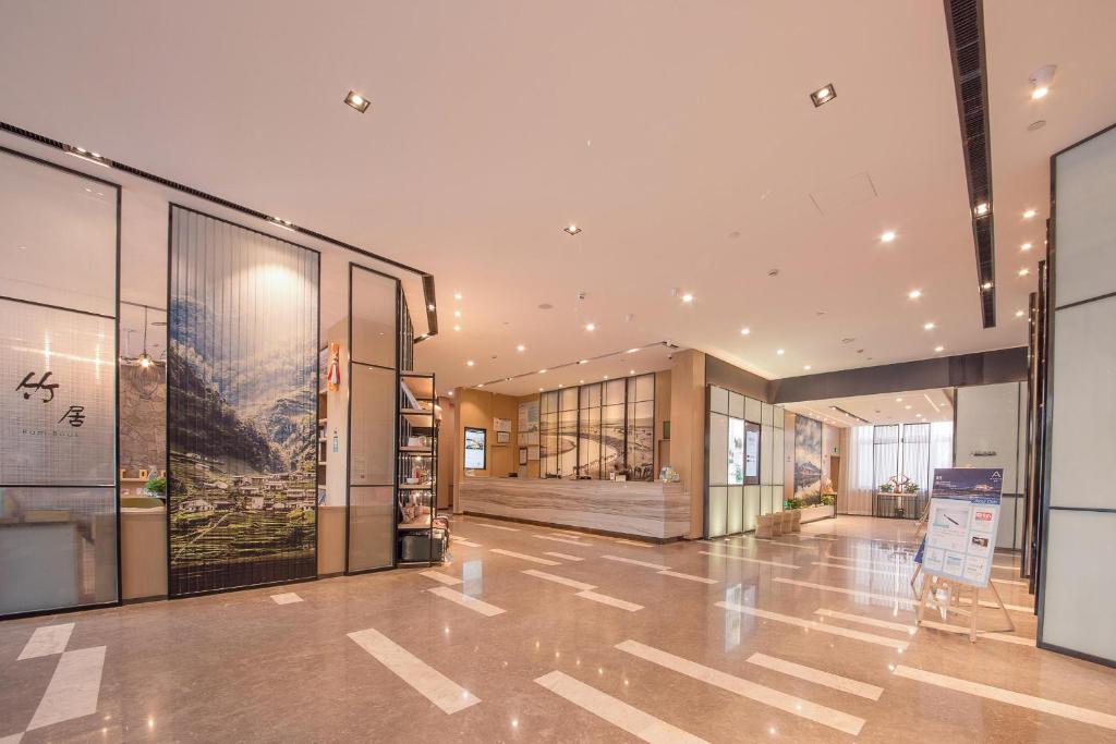 un grand bâtiment avec un hall doté de fenêtres en verre dans l'établissement Atour Hotel Hohhot Drum Tower Manduhai, à Hohhot